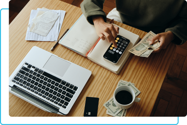 a person using a calculator and counting cash