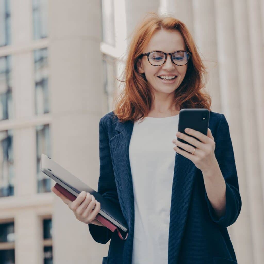 executive monitoring access via phone while walking in the city