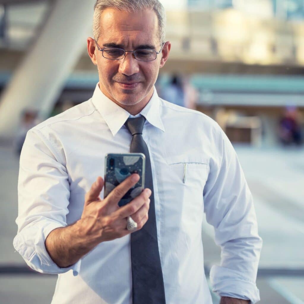 business person looking at phone