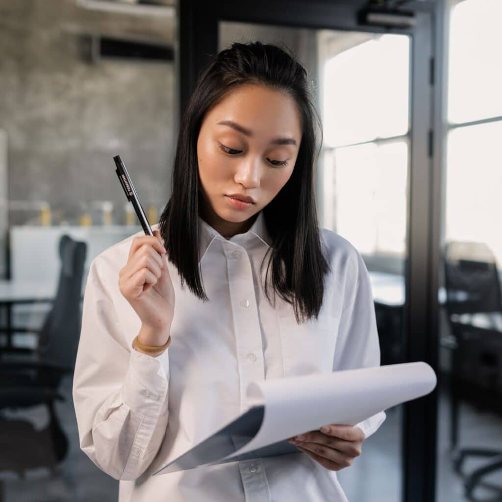 a woman taking notes on a clipboard