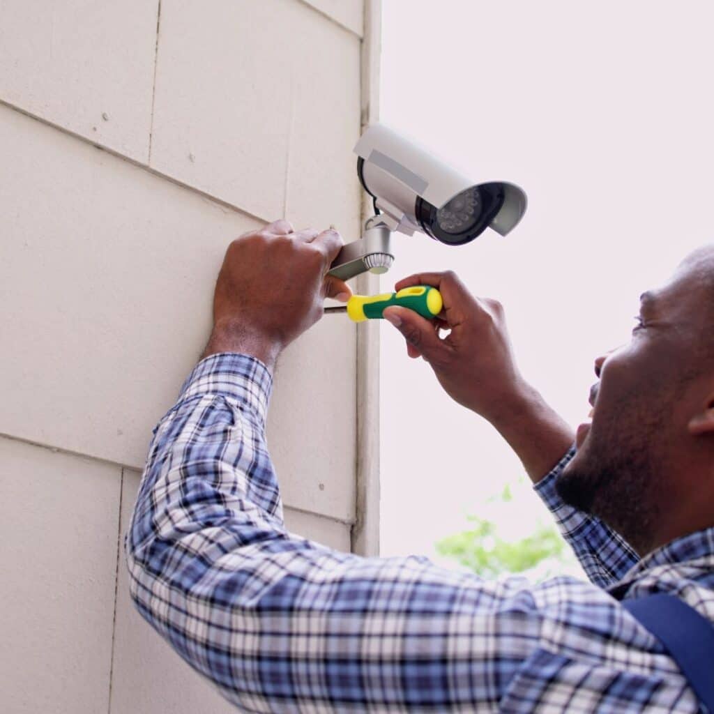 a man installing a security camera